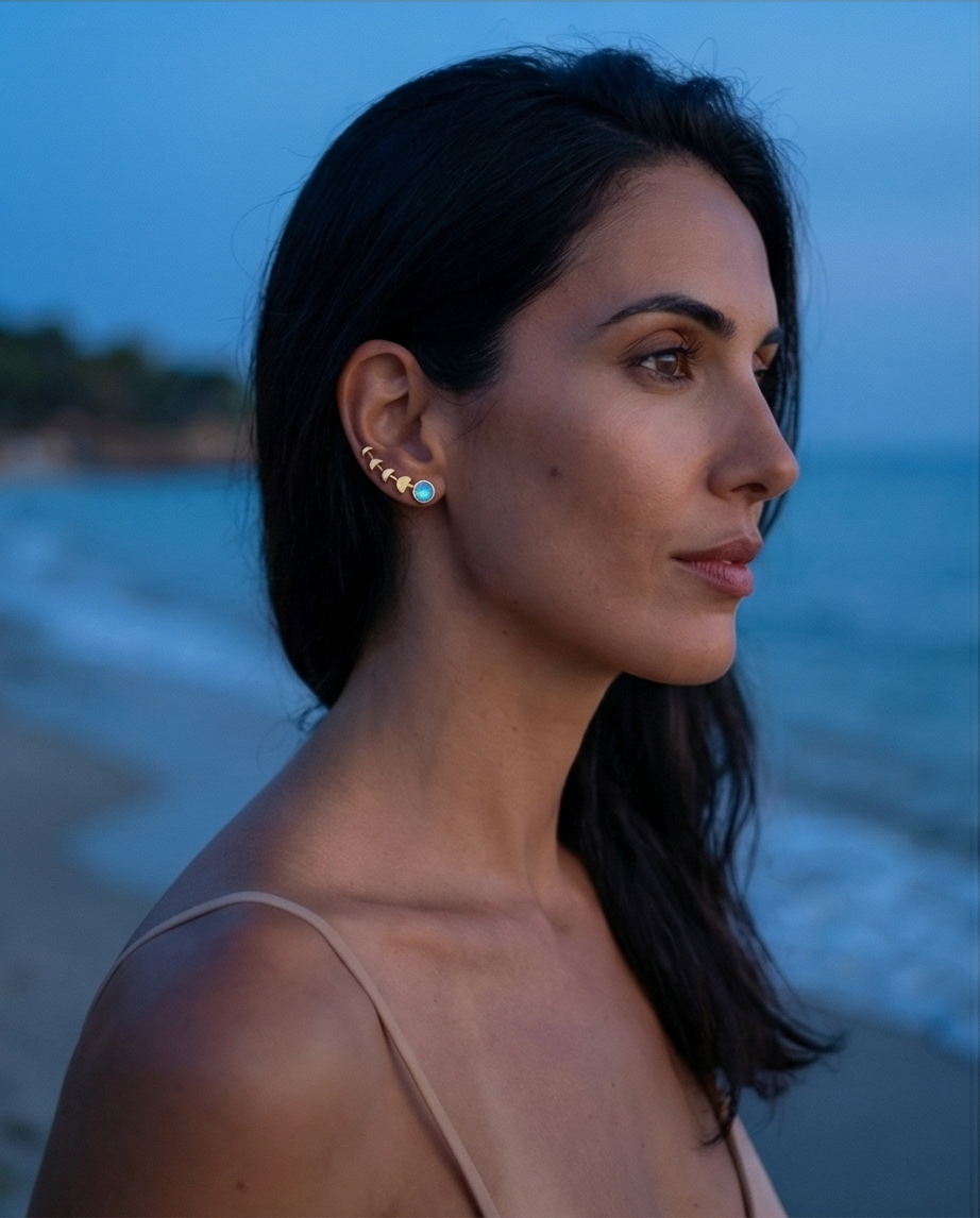Woman with ear climber on a beach at dusk